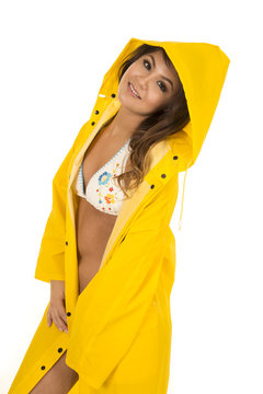 woman in white bikini in yellow rain coat side look