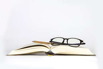 black rimmed glasses placed on opened book