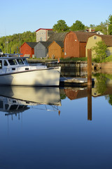 Boat Reflecting in Calm Water at Dock