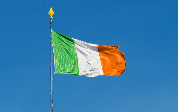 Ireland flag with pole waving blue sky text space vivid colors