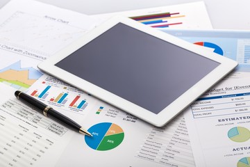 Investment. Financial charts on the table with tablet phone and