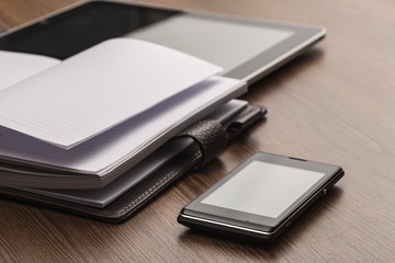 Appointment. Pen, notebook, mobile phone, tablet and discs in a