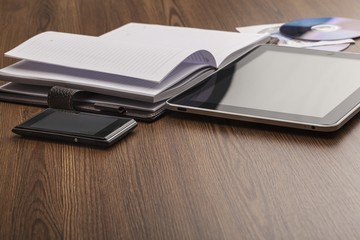 Appointment. Pen, notebook, mobile phone, tablet and discs in a
