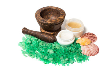 Wooden pounder with bottles of organic cream isolated