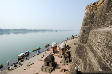 People walking in front of Maheshwar palace on India