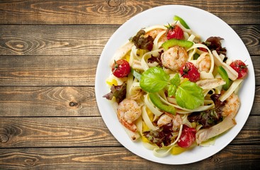Broccoli. Pasta with broccoli and shrimp on a plate, top view