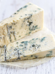 Various types of cheese on the wooden board