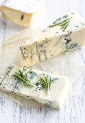 Various types of cheese on the wooden board