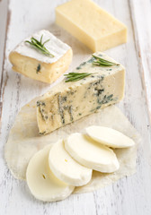 Various types of cheese on the wooden board