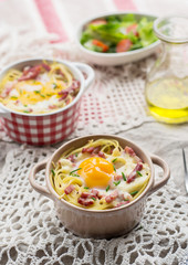 Baked pasta spaghetti carbonara with egg yolk, cheese and bacon