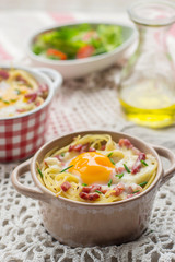 Baked pasta spaghetti carbonara with egg yolk, cheese and bacon
