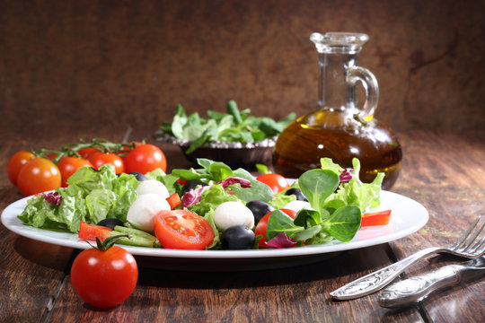Salad with a mozzarella, tomatoes, olives, salad