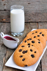 Glass of milk, raspberry jam and handmade cookies