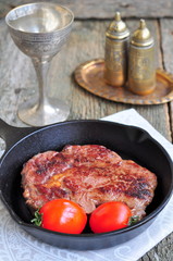 Juicy beef steak in a frying pan