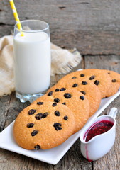 Glass of milk, raspberry jam and handmade cookies