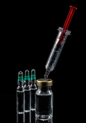 Red syringe with medical ampoules