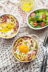 Baked pasta spaghetti carbonara with egg yolk, cheese and bacon