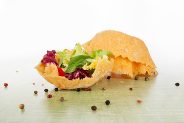 Mixed salad in cheese basket.