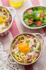 Baked pasta spaghetti carbonara with egg yolk, cheese and bacon