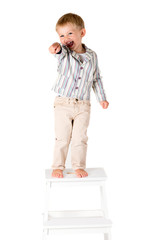 Boy shot in the studio on a white background standing pointing