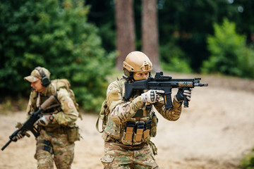 Fototapeta premium Soldiers team with guns watching territory