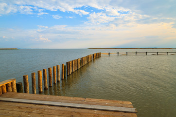 Fototapeta premium Wooden pier at Neusiedlersee lake in spring, Burgenland, Austria