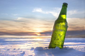 bottle of cold beer at sunset