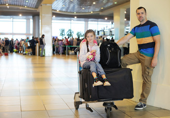 Fototapeta na wymiar Father and daughter with the luggage at airport