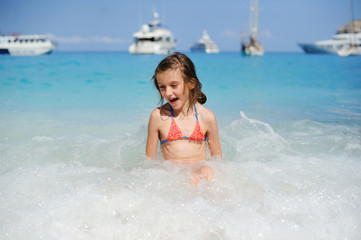 Young girl playing in the wave