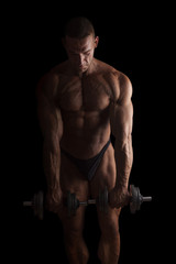 Fototapeta na wymiar Sexy bodybuilder lifting weights.