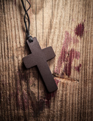 Cross on wooden background