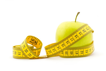 Healthy lifestyle concept. Green apple with measuring tape