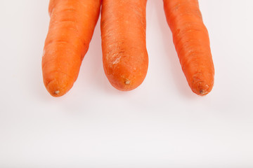 Three carrots on white background