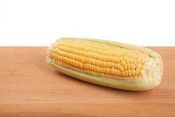Sweetcorn on wooden table