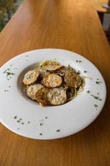 Spaghetti with a slice of grilled eggplant served