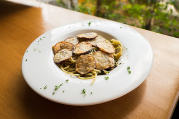 Spaghetti with a slice of grilled eggplant served