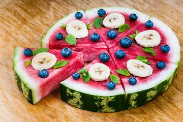 Watermelon pizza on wood