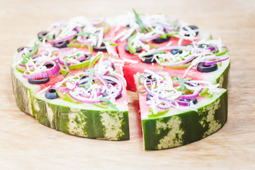 Watermelon pizza on wood