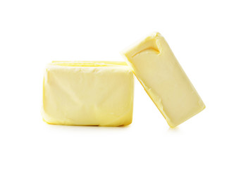 Stick of butter, cut, isolated on white.