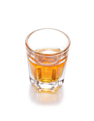 Whiskey in a shot glass isolated on a white background