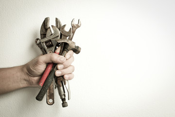 Hand of male holding old tools renovation on white background.