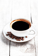 Coffee Espresso. Coffee cup with roasted coffee beans over white