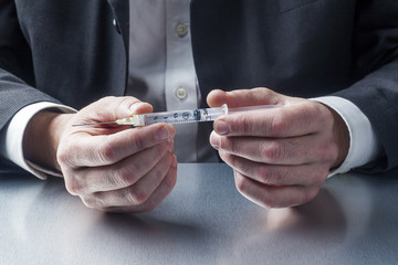 healthcare professional with needle symbol of treatment in hands