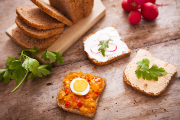 Homemade meal with bread and vegetarian spread on wooden background