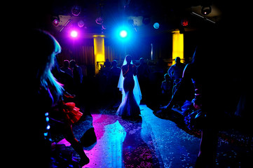 Silhouette of of bride dancing on the dance floor