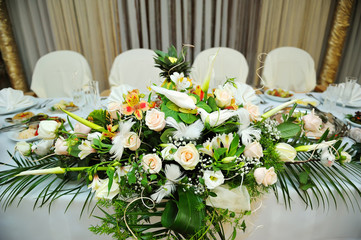 White bouquet of flowers on a festive table bride and groom
