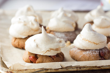 Shortbread cookies with peanut and meringues on cooking paper