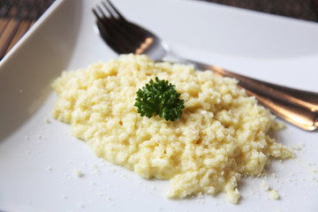 risotto dish with herbs on wood background