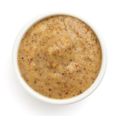 Typical czech mustard in round dish from above on white.