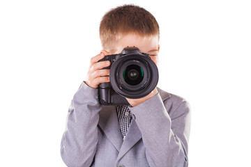 Fototapeta premium kid holding a dslr camera isolated on the white